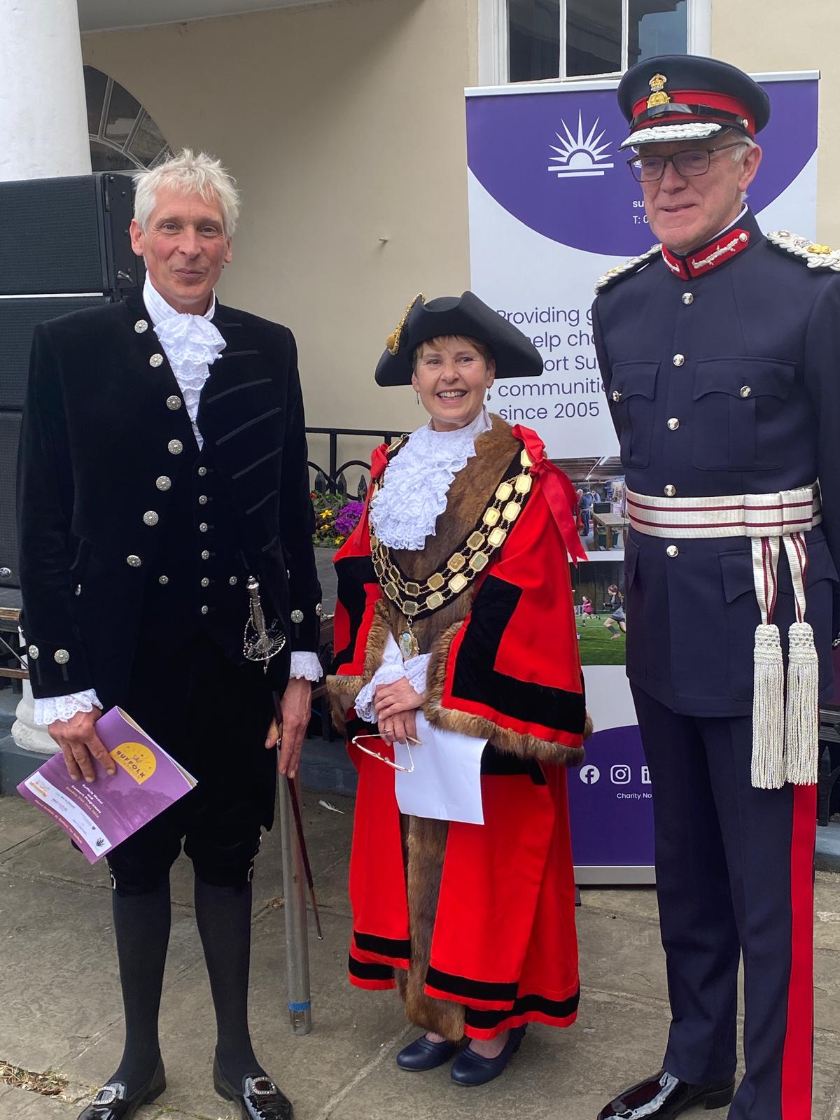 A group of three people, all in official regalia 
