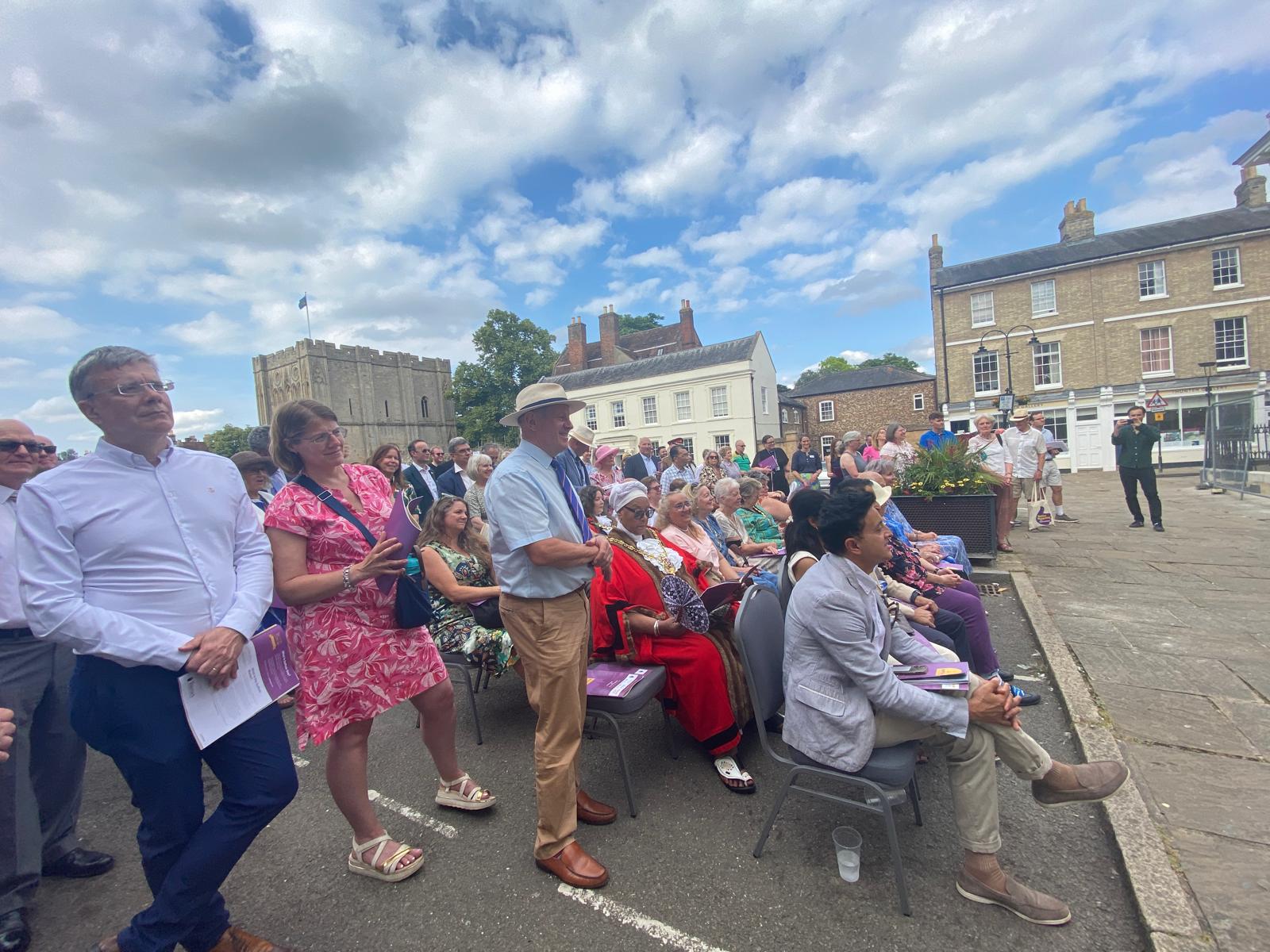A crowd of people watching an outdoor event