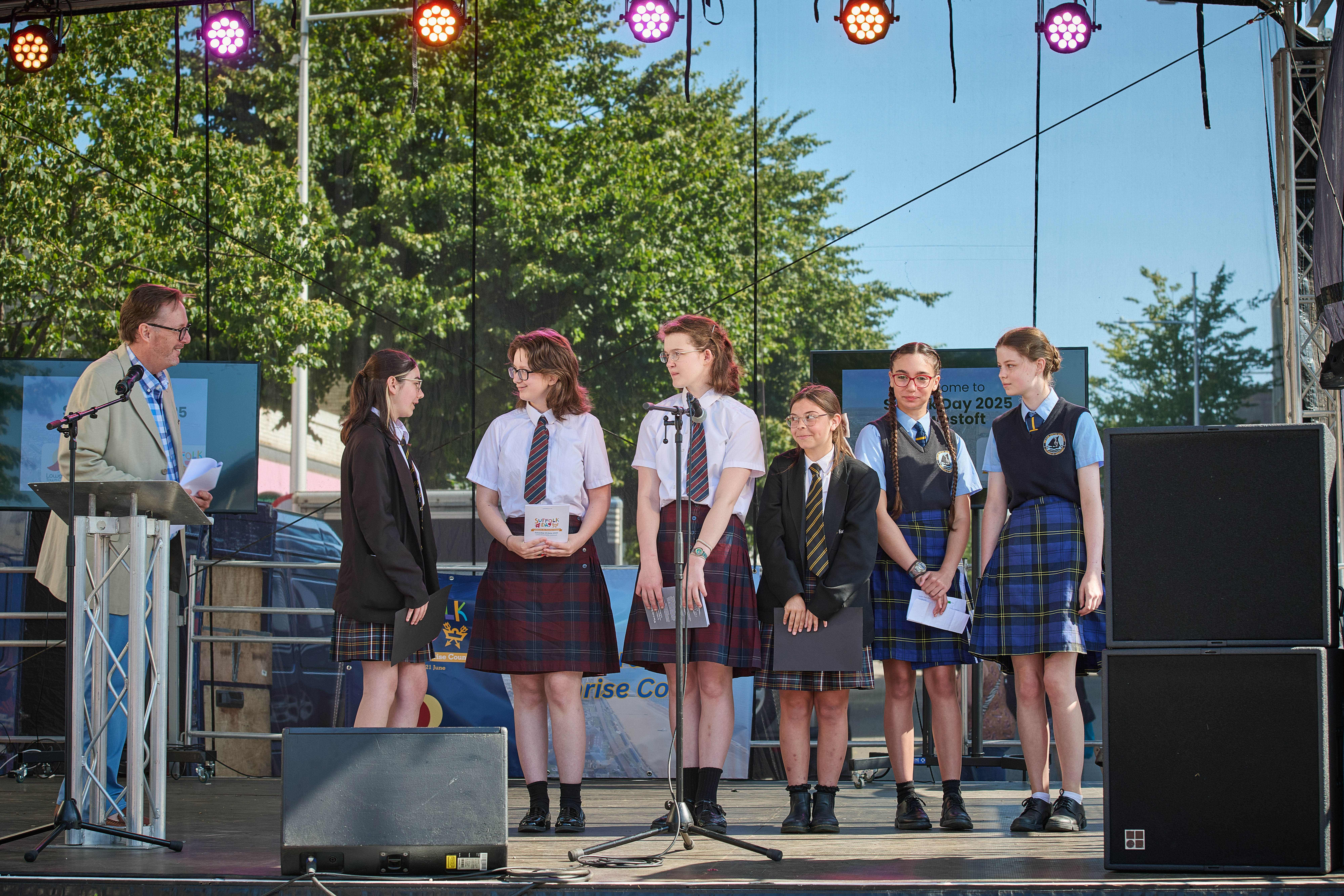 A small group of school pupils on stage at the Suffolk Day events 