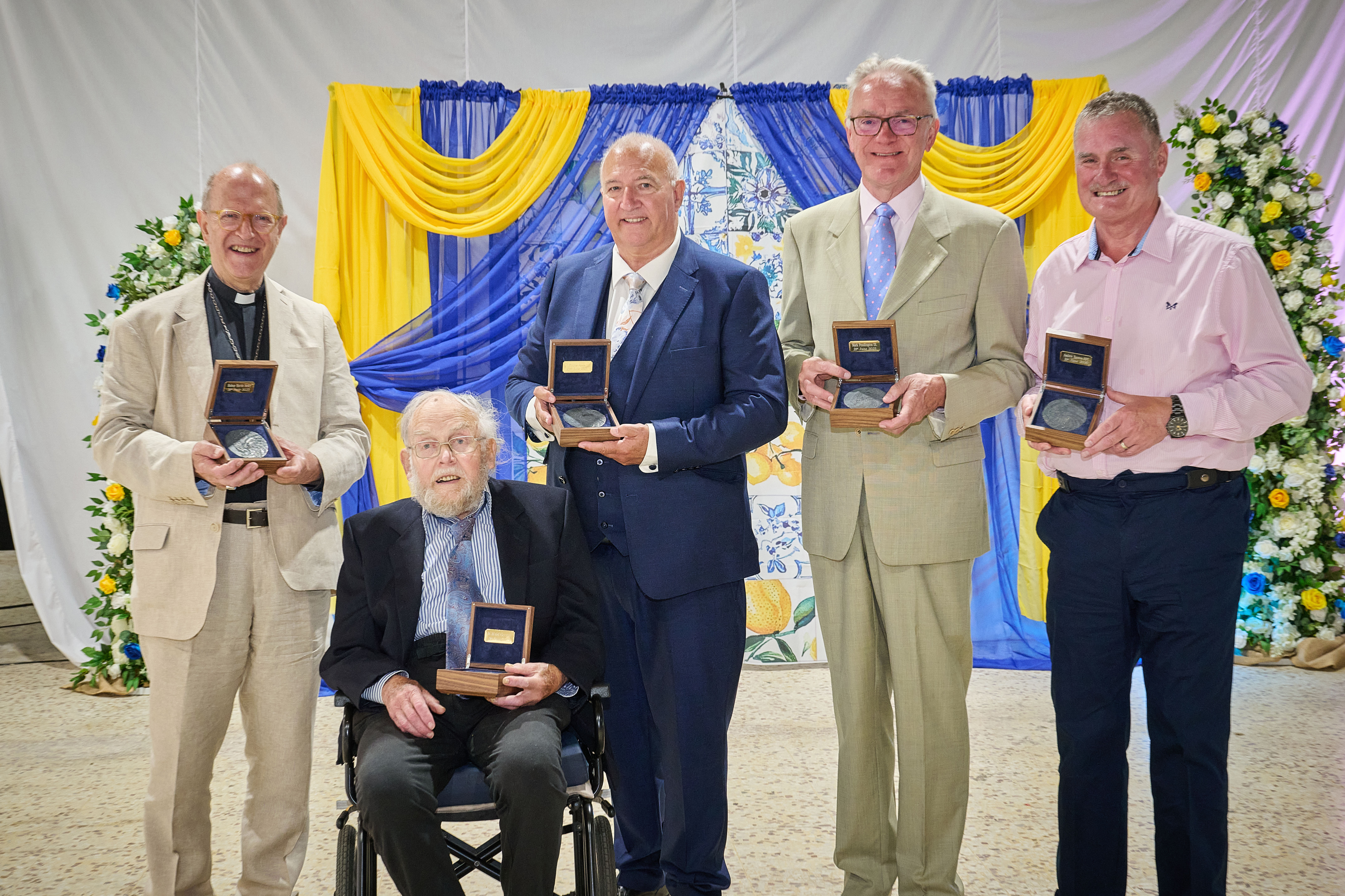 Five men holding Suffolk Medal boxes 